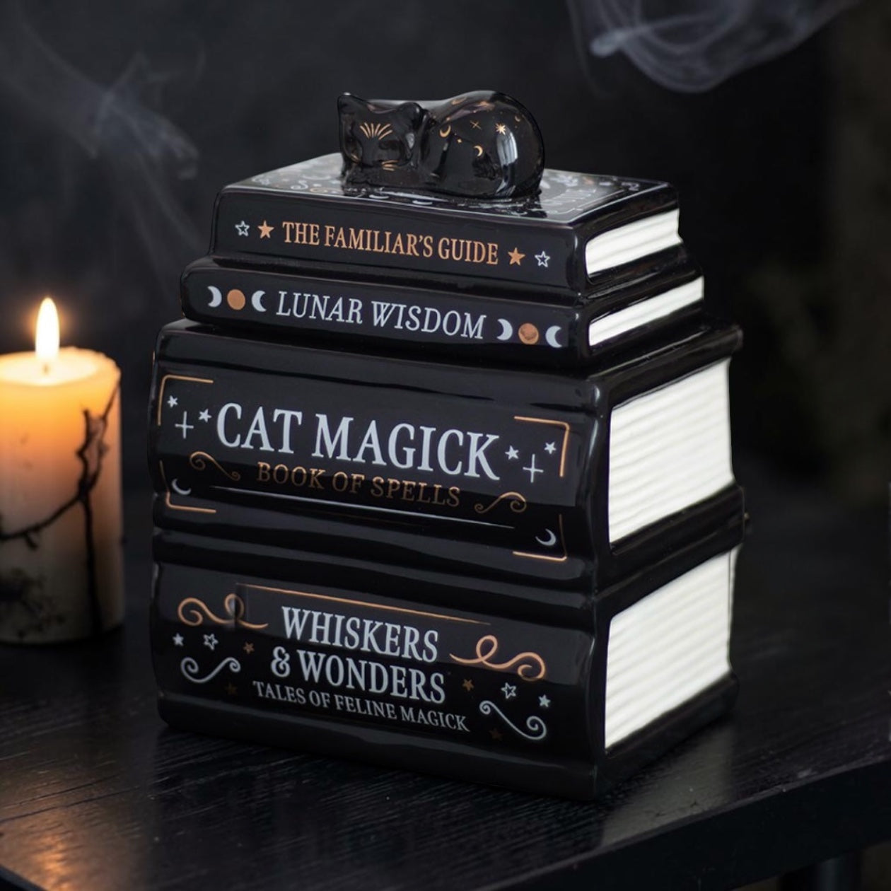 Black Book Stack With Cat Burner